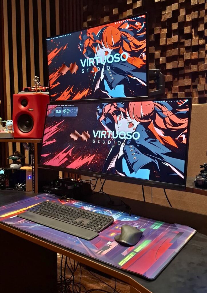 Professional audio studio setup with dual monitors, studio monitor speaker, and recording equipment.