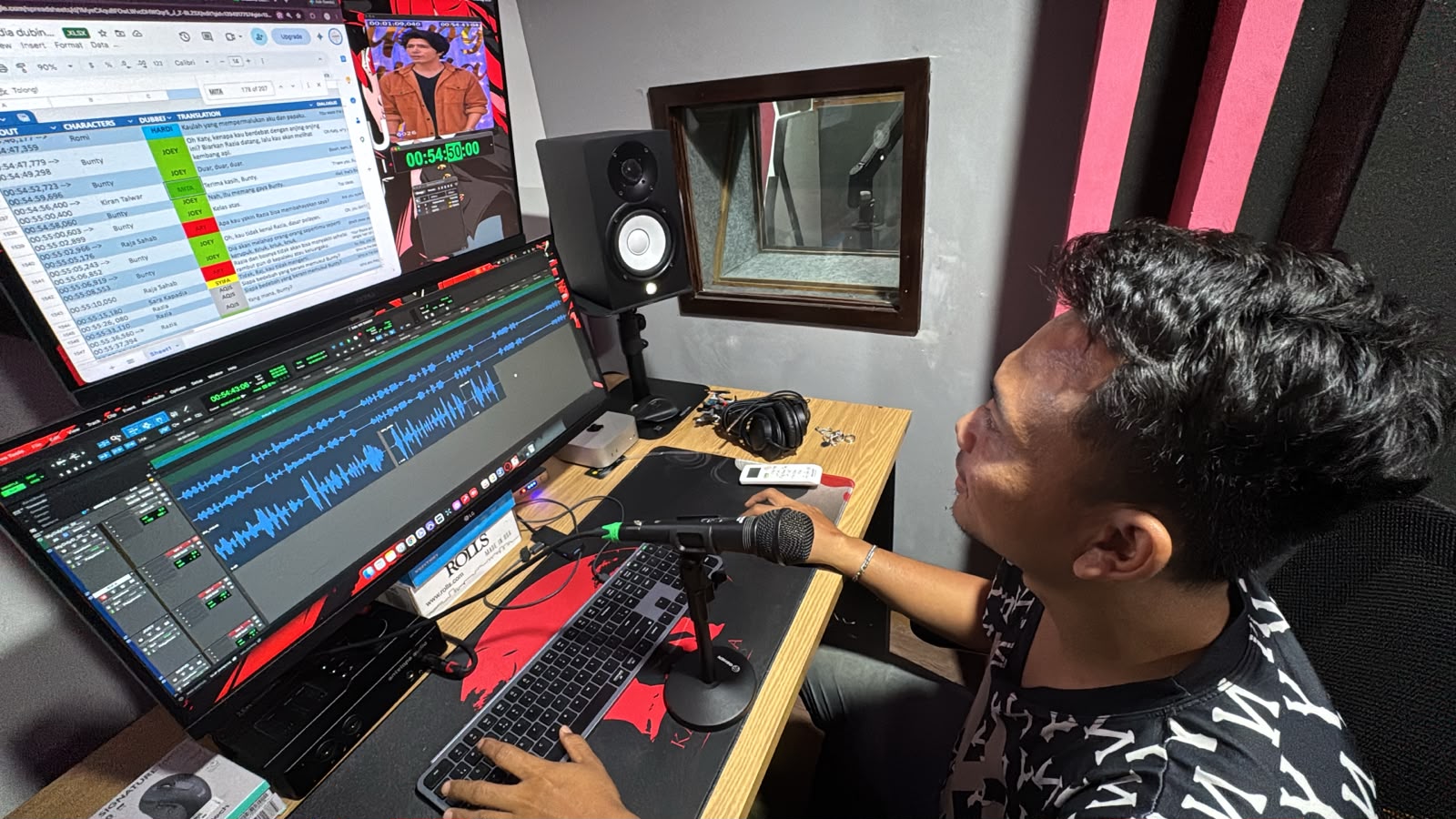 Audio editor working on a voice recording in a professional studio.